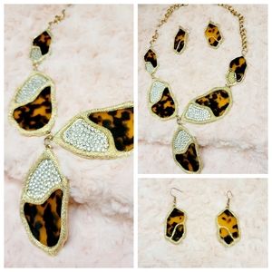 A stunning and eye-catching gold leopard necklace and earring set, complemented